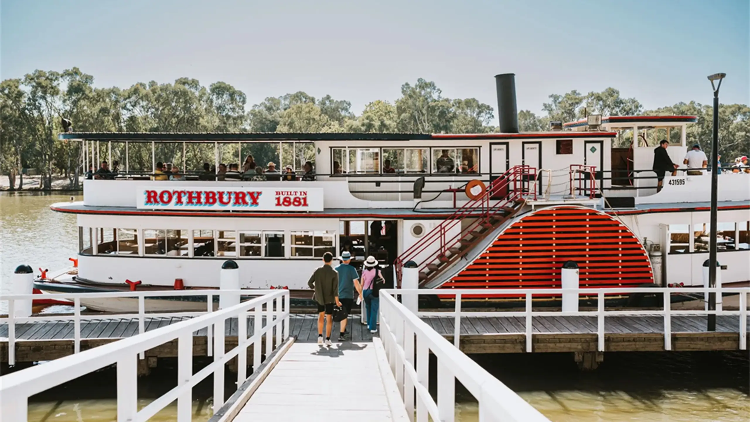 People boarding a paddle steamer boat called Rothbury.