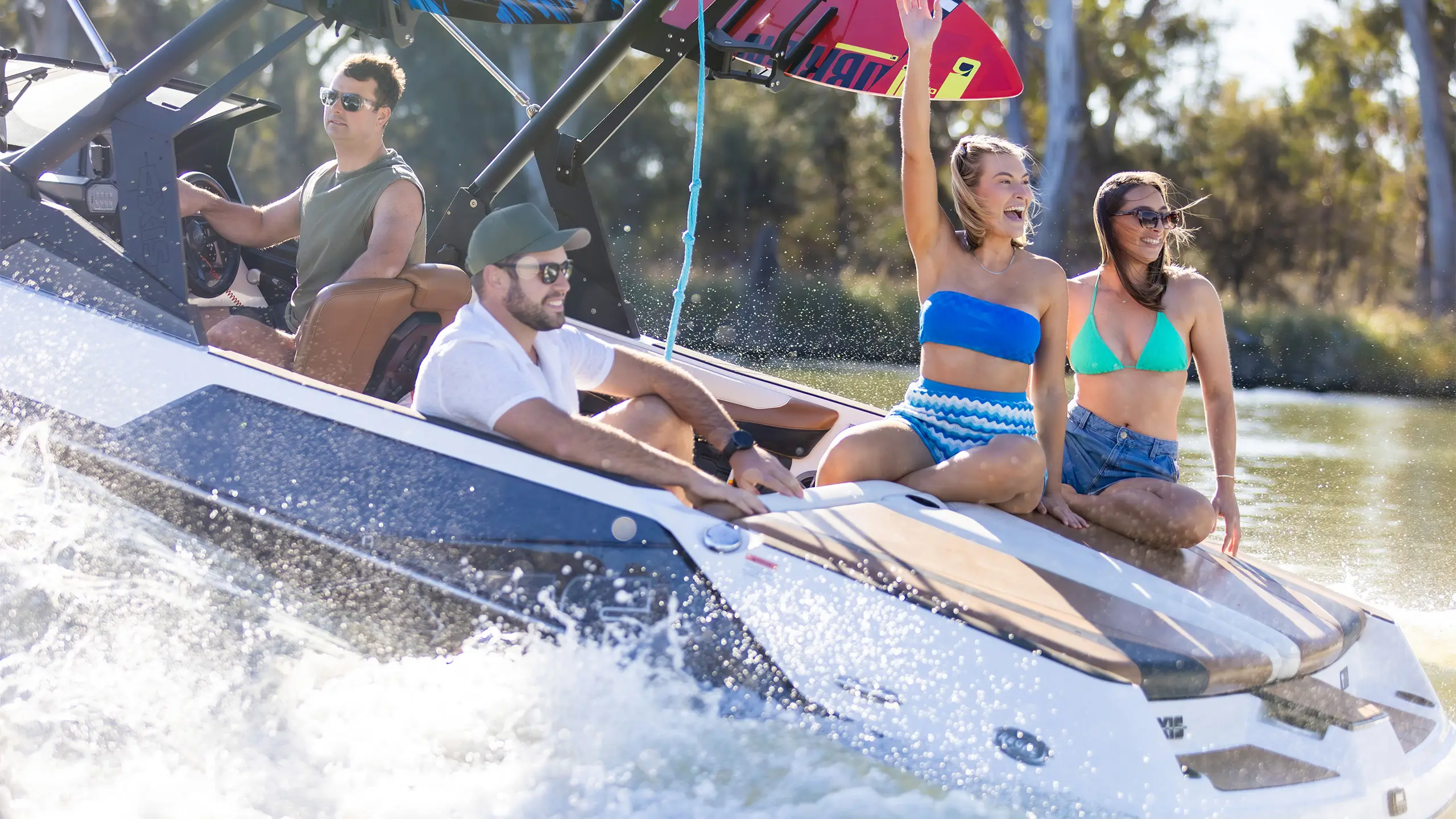 Two men and two women on a boat enjoying the Murray River.