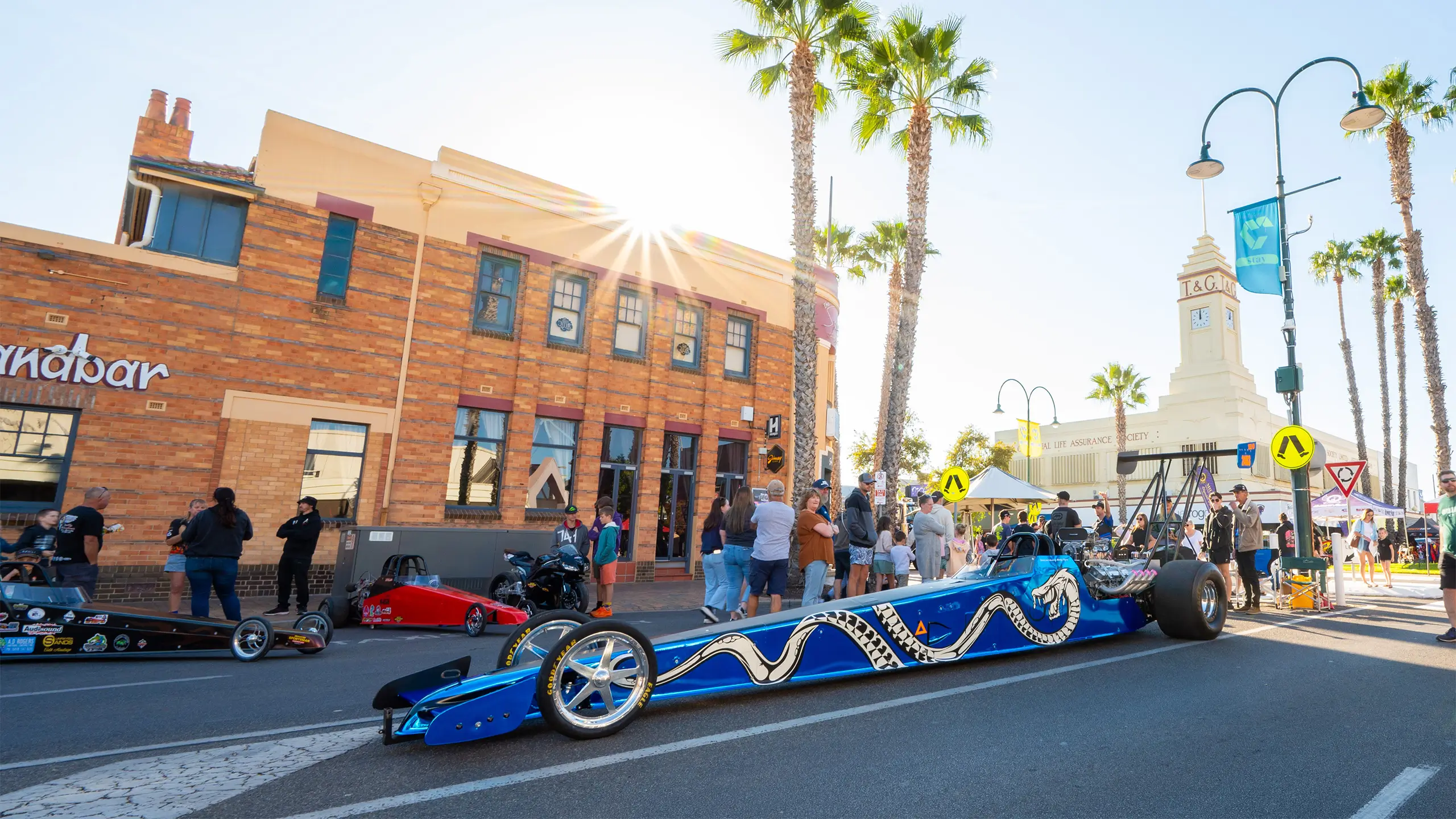 A blue top fuel dragster, a racing car, in front of the Sandbar building in Mildura.