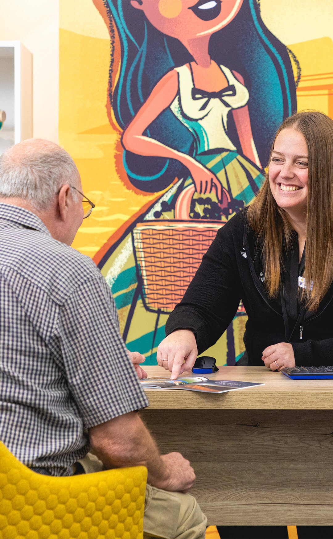 An expert helping a tourist at the Mildura information centre